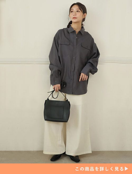 モカチャコールのシャツにホワイトワイドパンツを合わせる女性