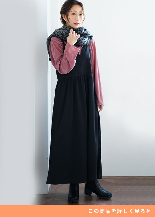 くすみピンクのトップス×黒のキャミワンピのセットアップを着る女性