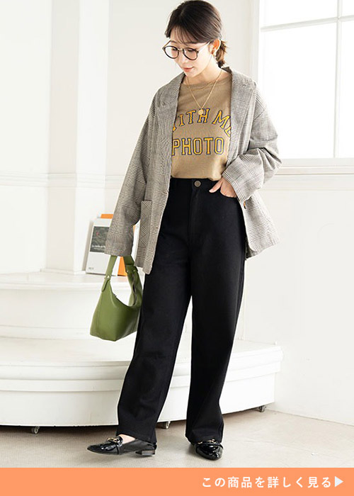 茶系のロゴT×黒のワイドチノパンにジャケットを羽織る女性