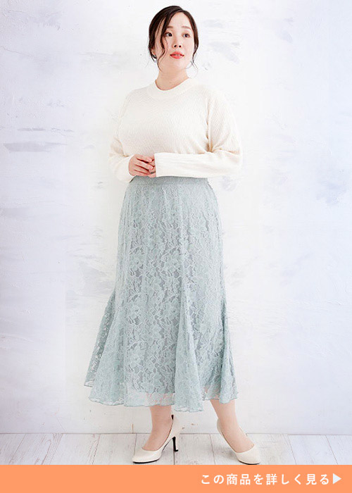 ミントグリーンのレースマーメイドスカートにシンプルな白トップスをインして着る女性