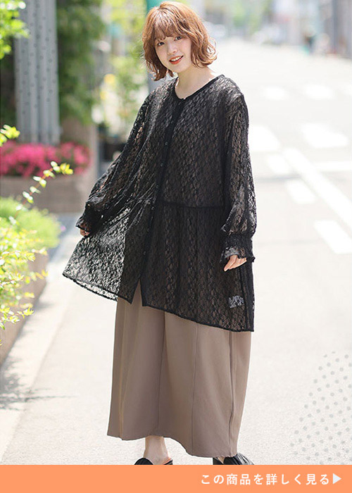 ベージュのボトムにシアー素材のカーディガンを合わせた女性