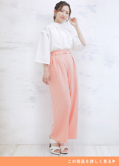 左手を頬に添えてポーズをとる女性