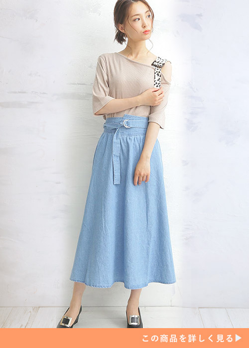 ベルト付スカートとベージュのトップスのコーデにパンプスを履く女性