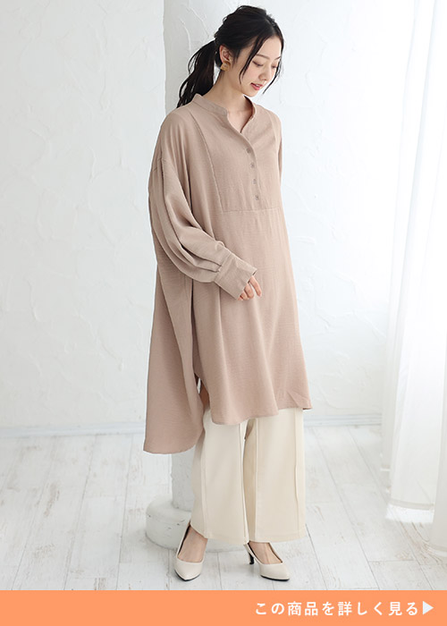 ミルキーベージュのシャツワンピース×アイボリーのパンツを着る女性