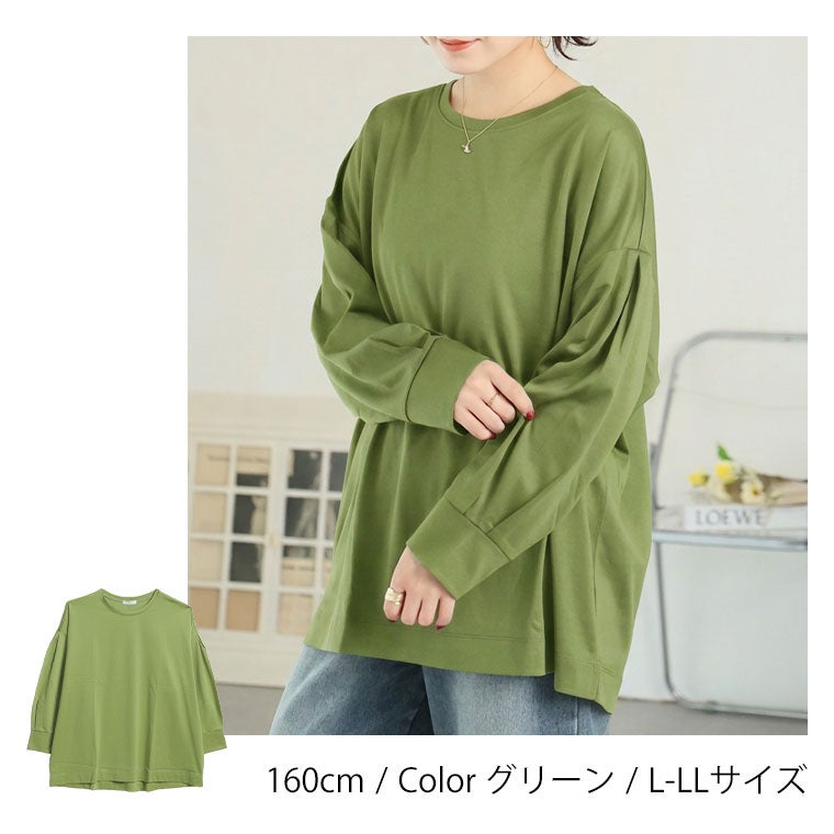 デニムパンツにグリーンのロングTシャツを着る女性